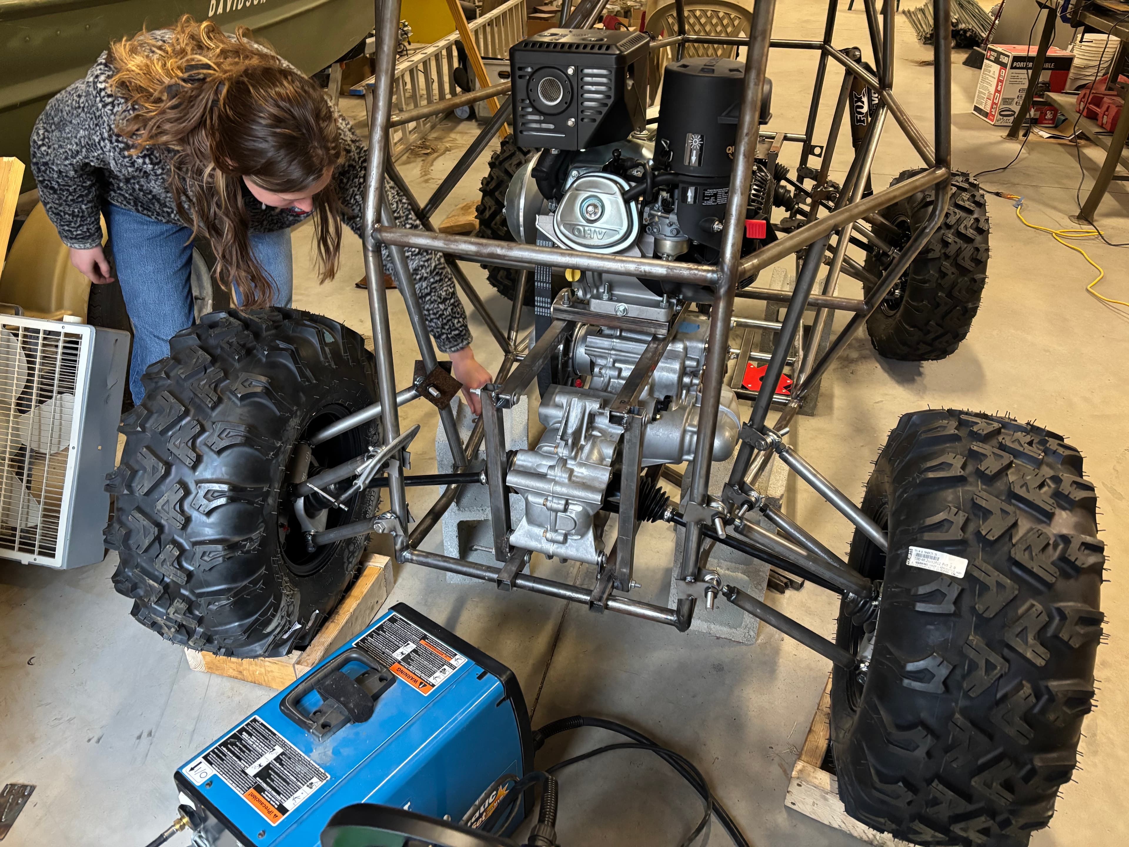 Team member working on suspension area from above