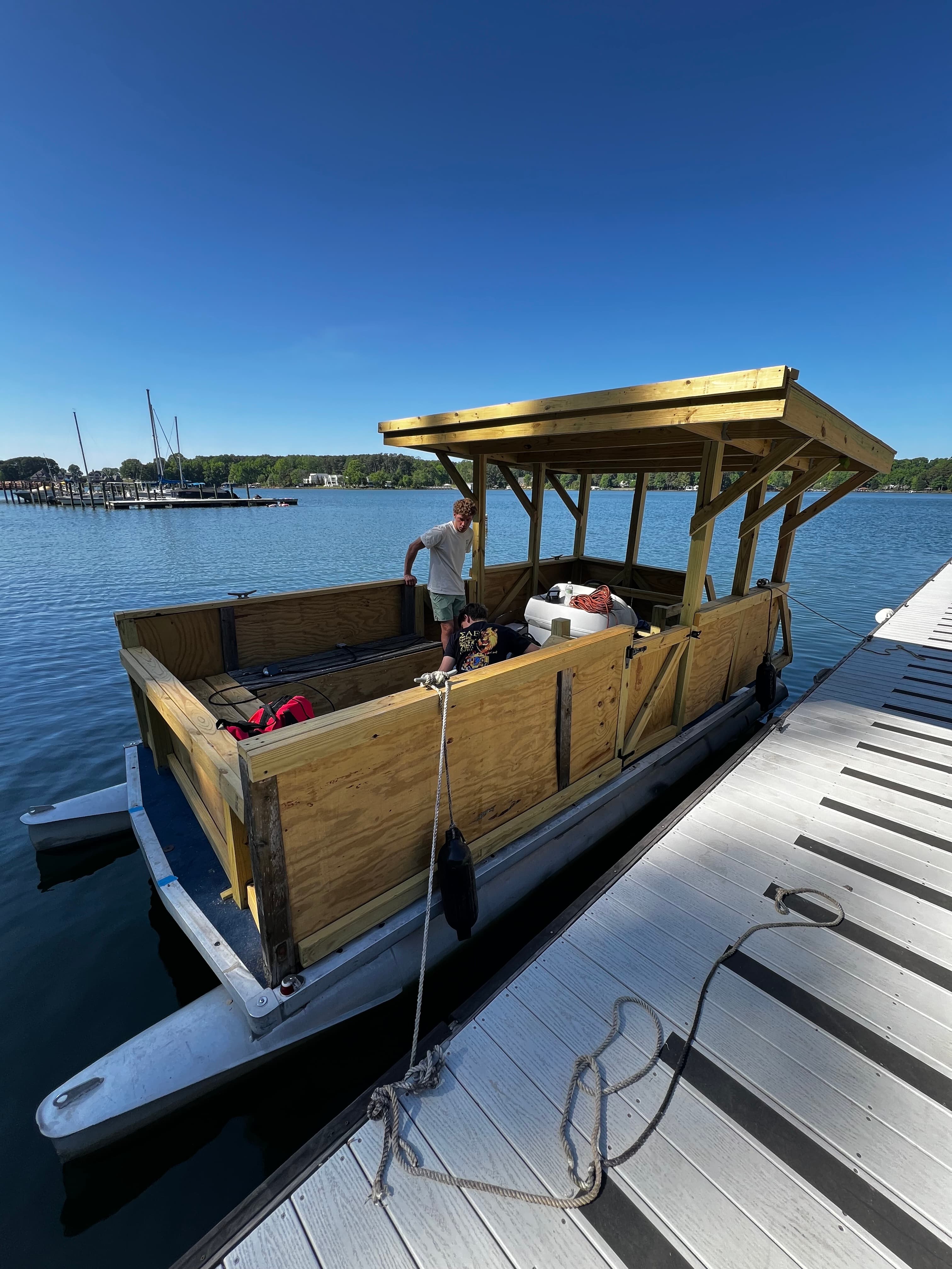 Boat tied at dock under blue sky during first water test