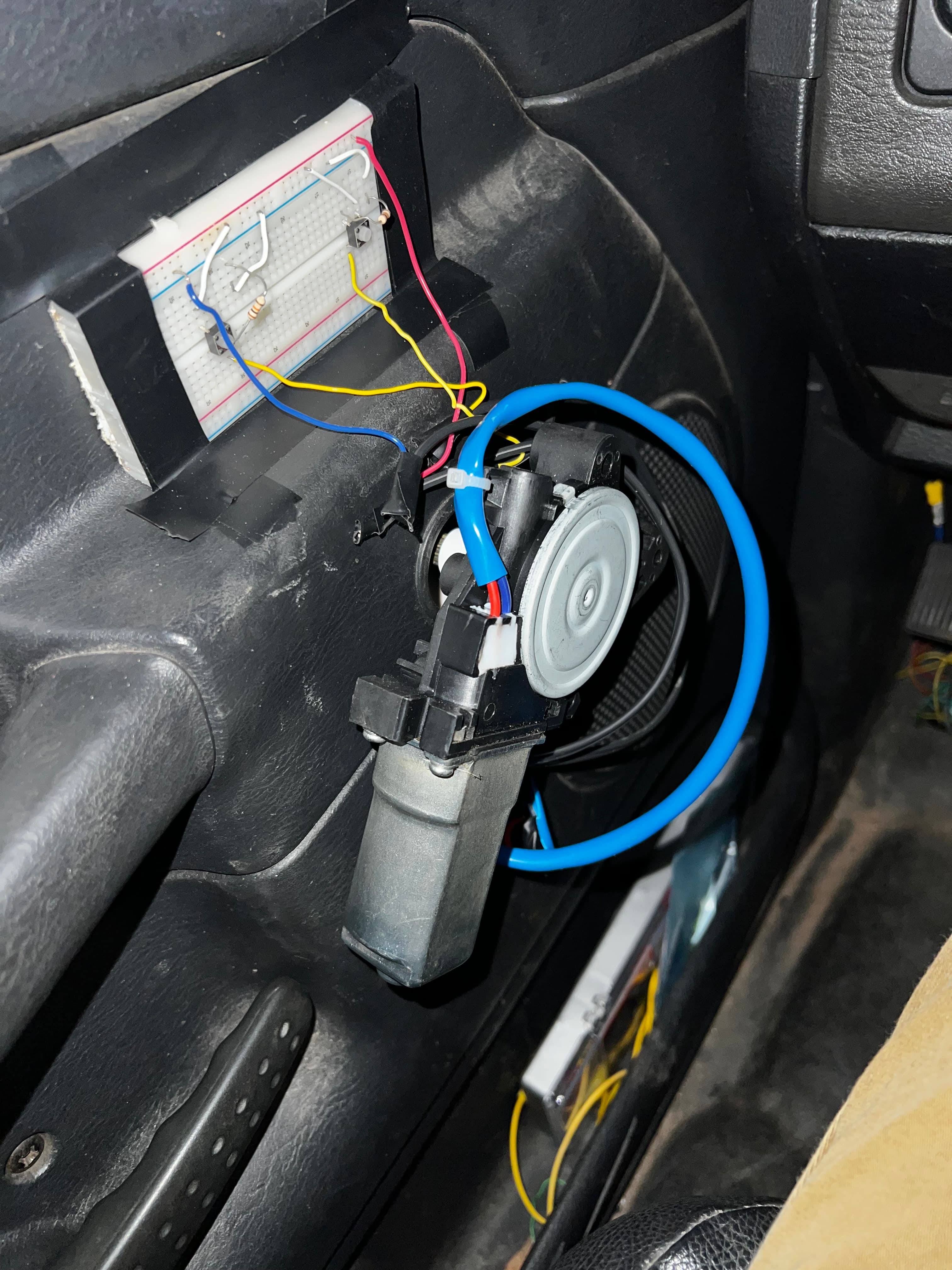 Inside the truck door showing motor mounted with breadboard and wiring visible